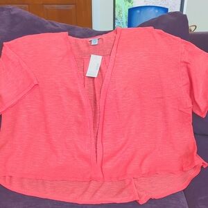 A summer bright orange jacket that swoops lower in back